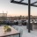 a patio with a table and chairs and a view of a city