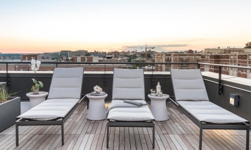 a deck with chairs and a view of a city