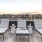 a deck with chairs and a view of a city