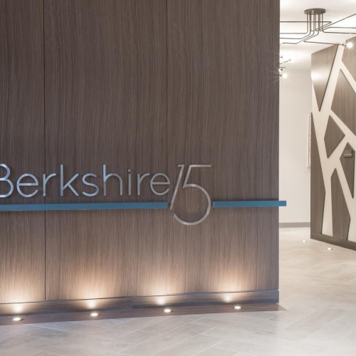 Settle into comfort at Berkshire 15 a room with a wood floor and a white door