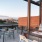 a patio with a table and chairs and a view of a city